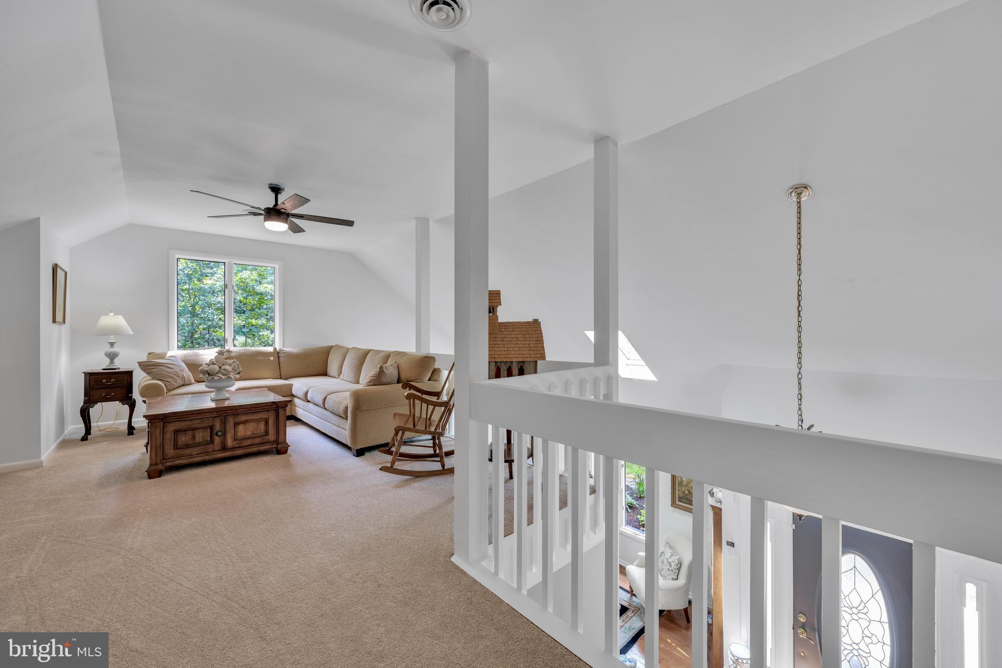 292 Pond Road Millsboro, DE 19966 - Photo 41 of 66 a living room with furniture stairs and a window