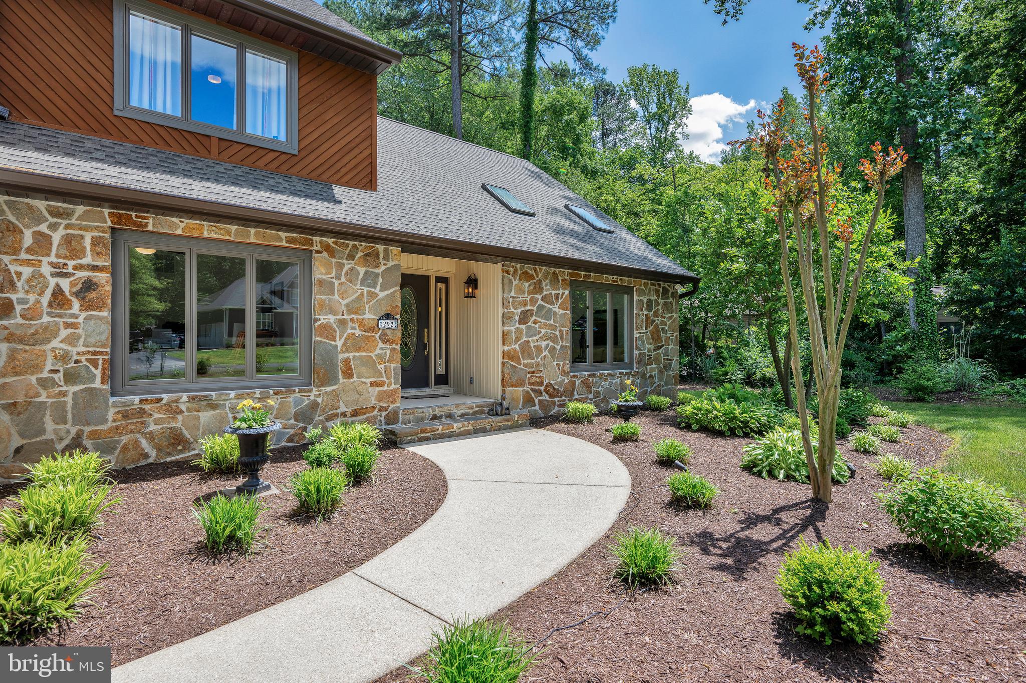 292 Pond Road Millsboro, DE 19966 - Photo 49 of 66 a front view of a house with garden