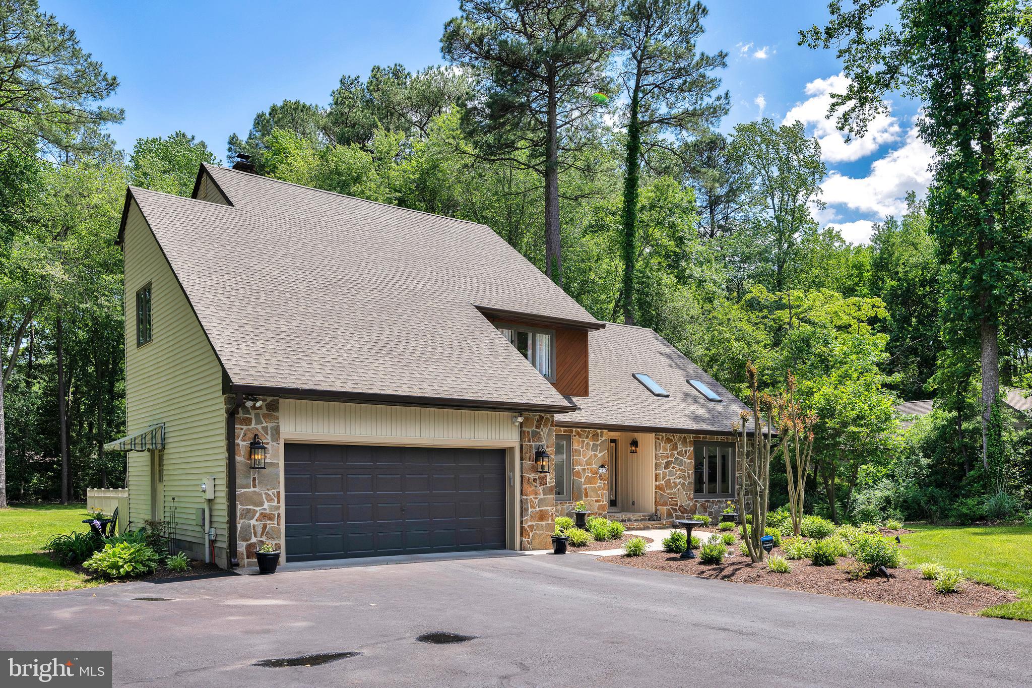 292 Pond Road Millsboro, DE 19966 - Photo 50 of 66 a front view of a house with a yard and garage
