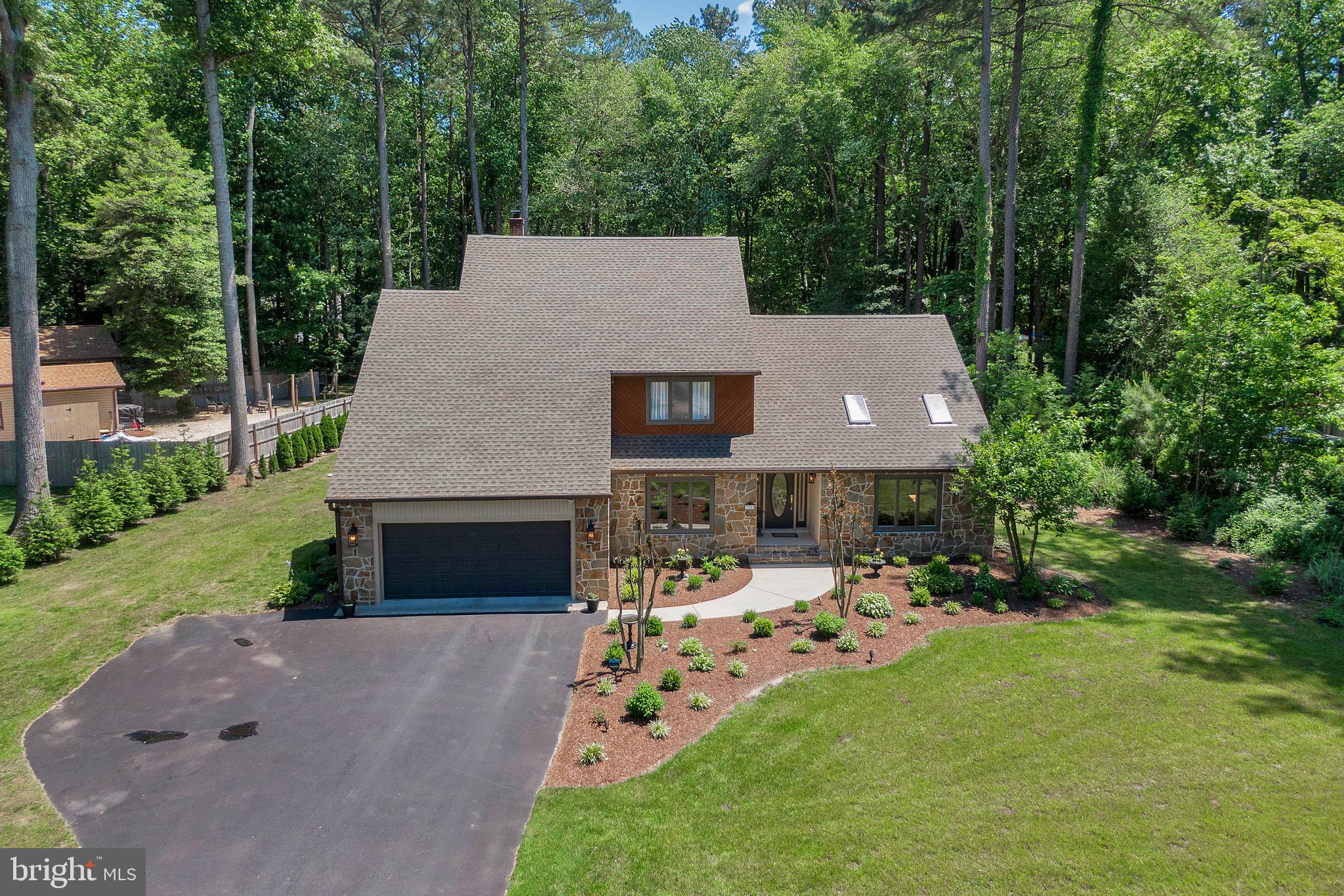 292 Pond Road Millsboro, DE 19966 - Photo 55 of 66 a aerial view of a house with table and chairs with a fire pit