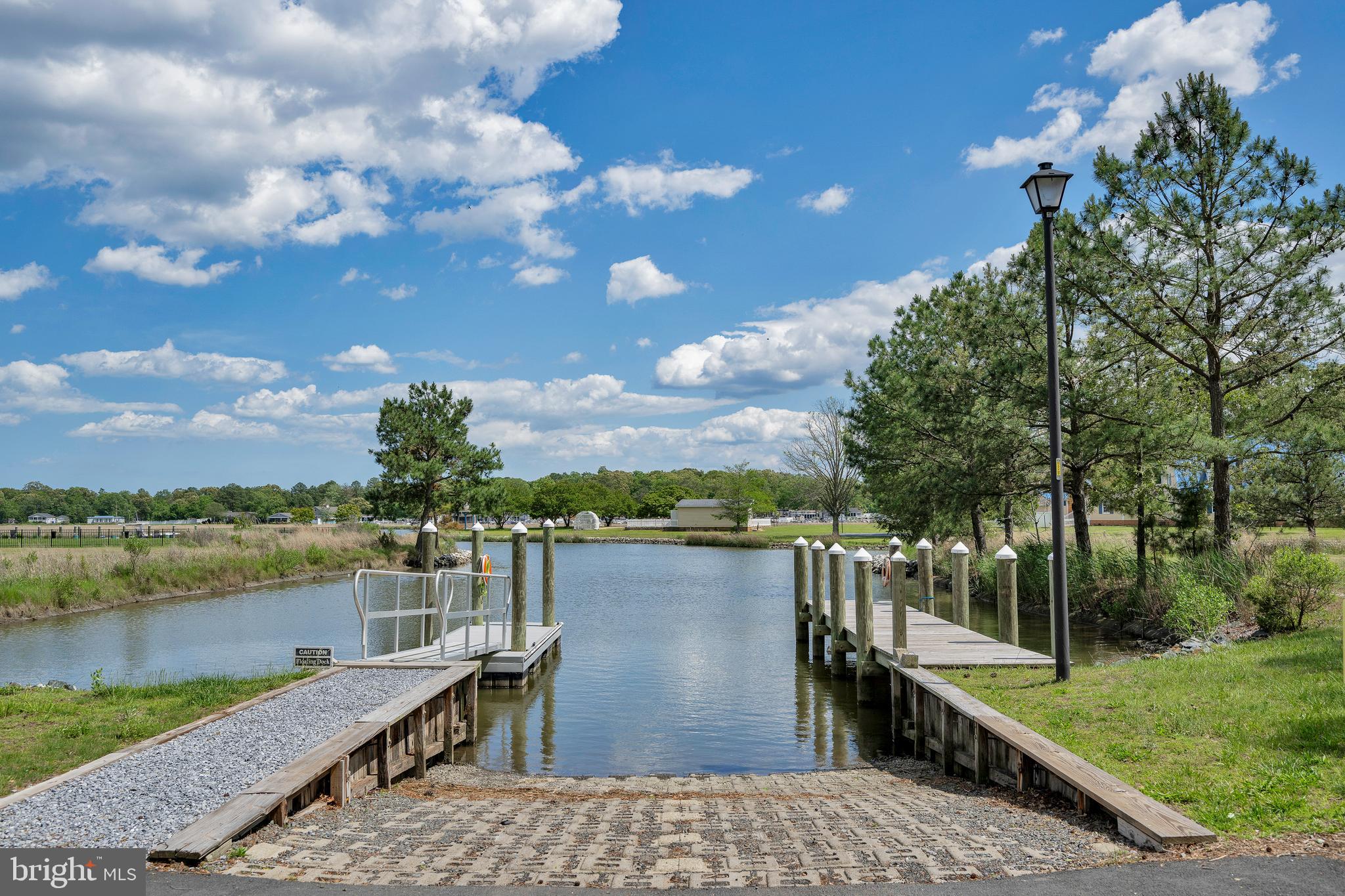 292 Pond Road Millsboro, DE 19966 - Photo 61 of 66 a view of a lake with a terrace