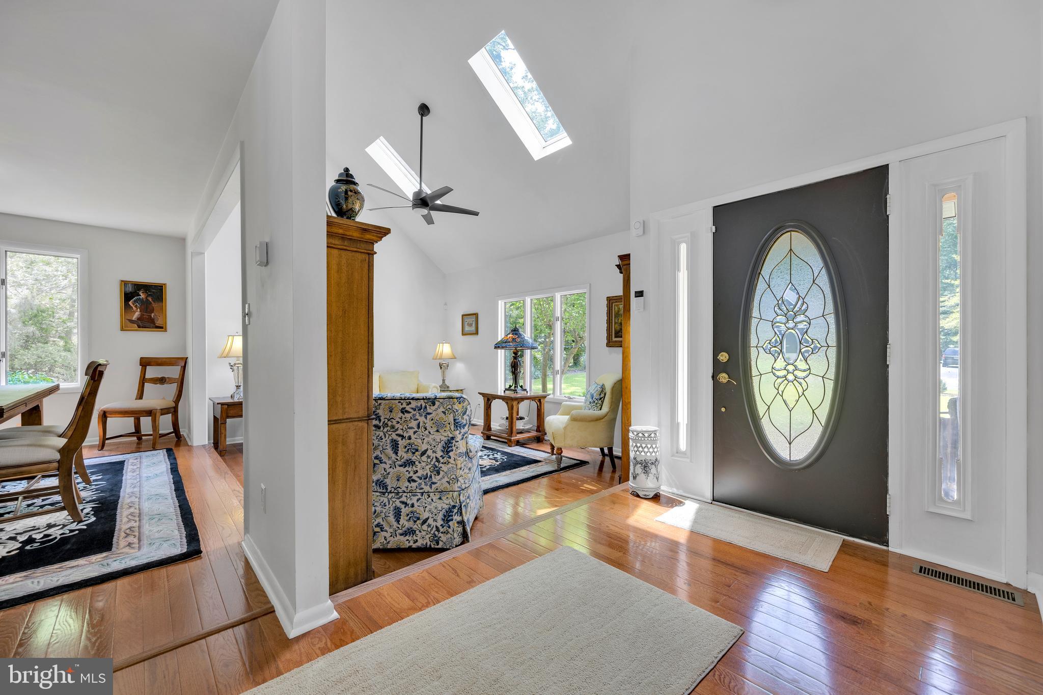 292 Pond Road Millsboro, DE 19966 - Photo 9 of 66 a view of a hallway with furniture and wooden floor