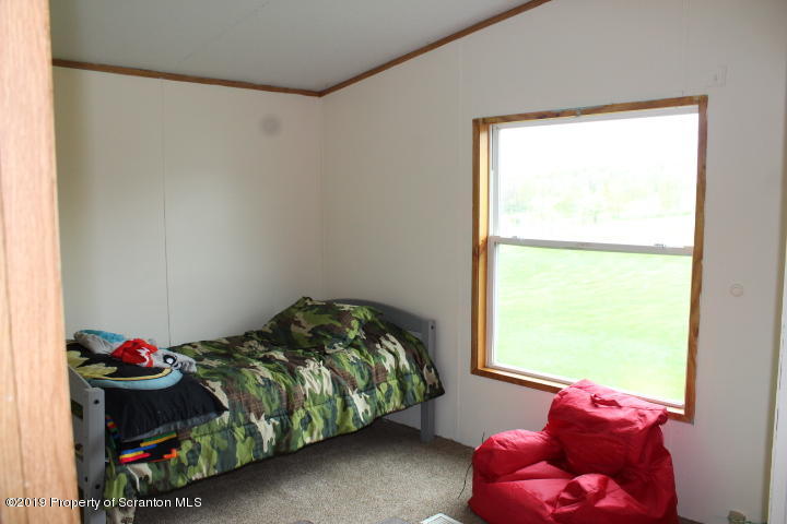 1415 Bennett Road Hop Bottom, PA 18824 - Photo 8 of 26 a bedroom with a bed and a window