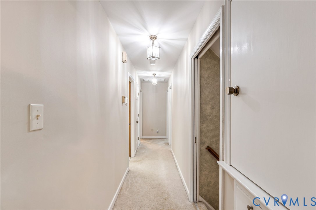 5700 Elfinwood Road Chester, VA 23831 - Photo 22 of 38 a view of a hallway with wooden floor and a bathroom