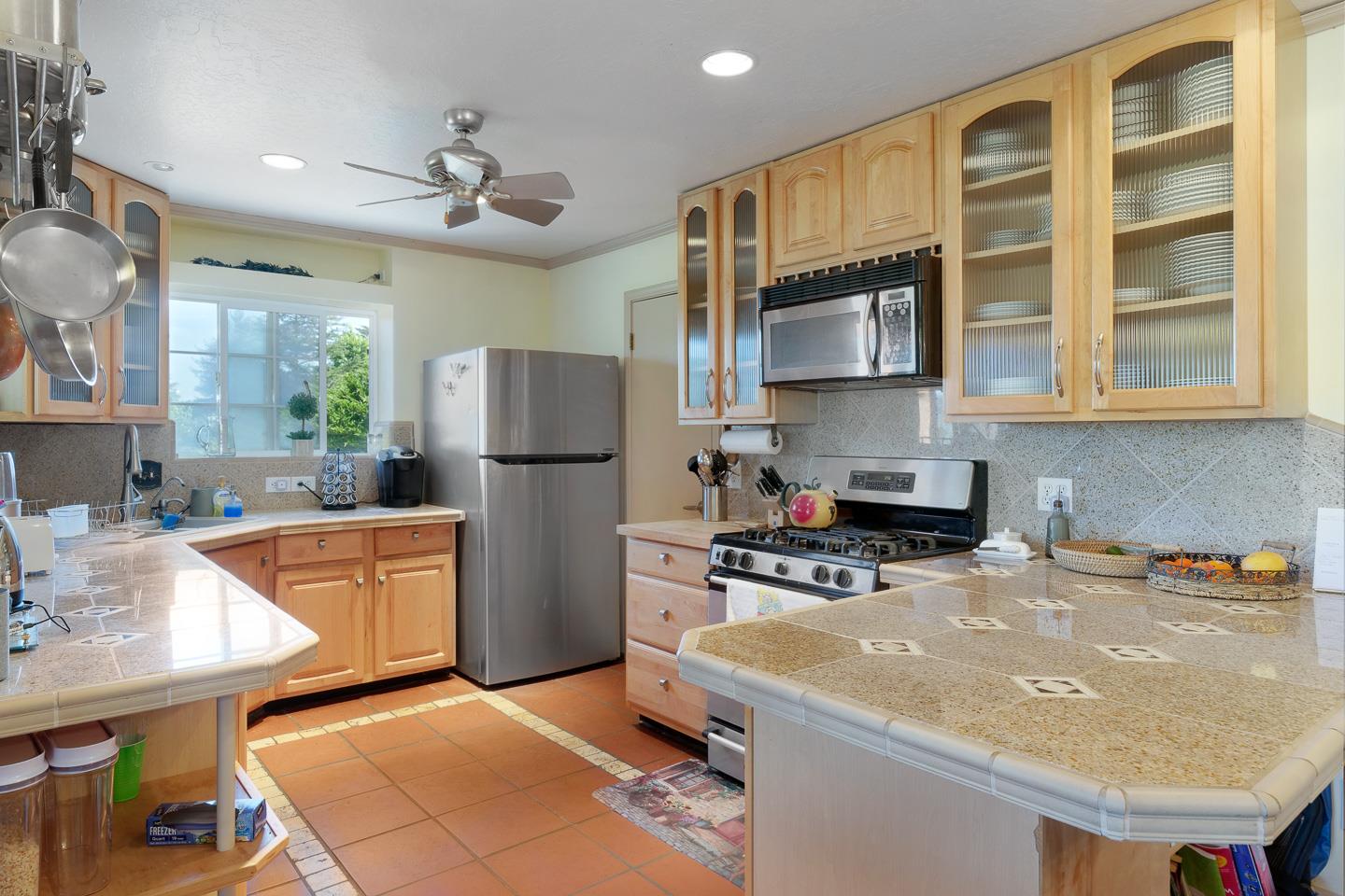 260 Rancho Soquel Drive Soquel, CA 95073 - Photo 16 of 41 a kitchen with stainless steel appliances granite countertop a sink refrigerator and cabinets