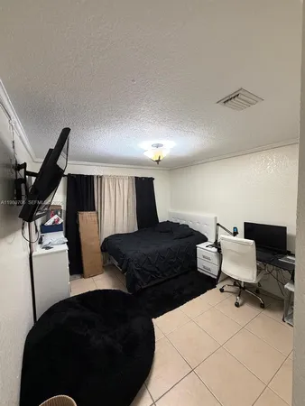 a bedroom with a bed and chair