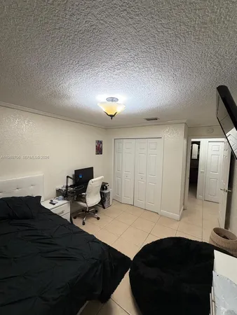 a room with a bed and a dresser