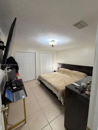 a bedroom with a bed and a closet