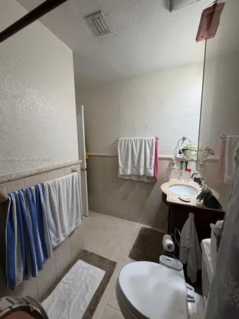 a bathroom with a sink a toilet and mirror