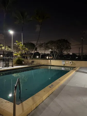 a view of a swimming pool with a yard