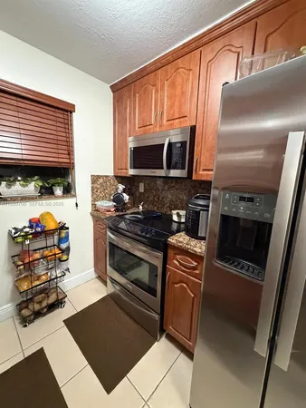 a kitchen with granite countertop a stove and a microwave