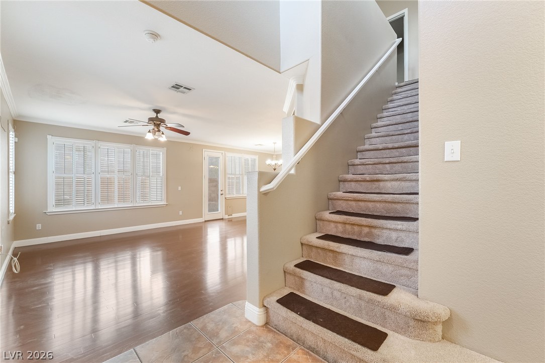 224 Positive Point Street Henderson, NV 89012 - Photo 18 of 44 Gleaming hardwood floors and a carpeted staircase anchor this open entryway.