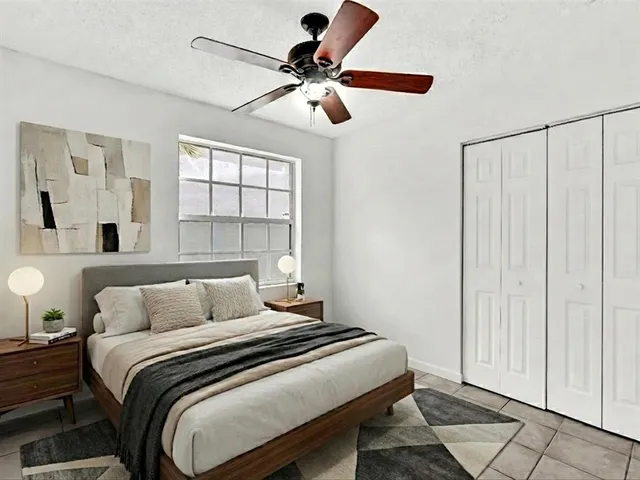 a bedroom with a bed and a window