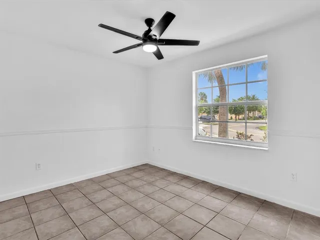 a view of a ceiling fan and a window