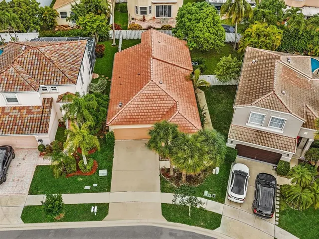an aerial view of a house with a yard and potted plants