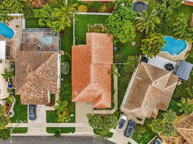 an aerial view of a residential houses with yard