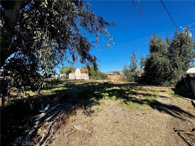 a view of a yard with wooden fence