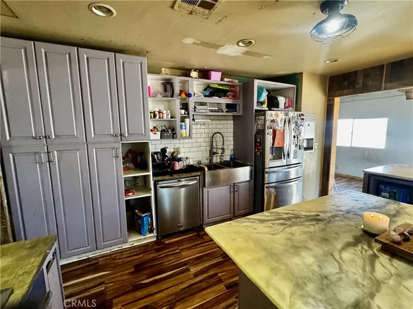 a kitchen with refrigerator and window