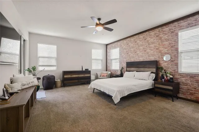 a spacious bedroom with a bed and a couch