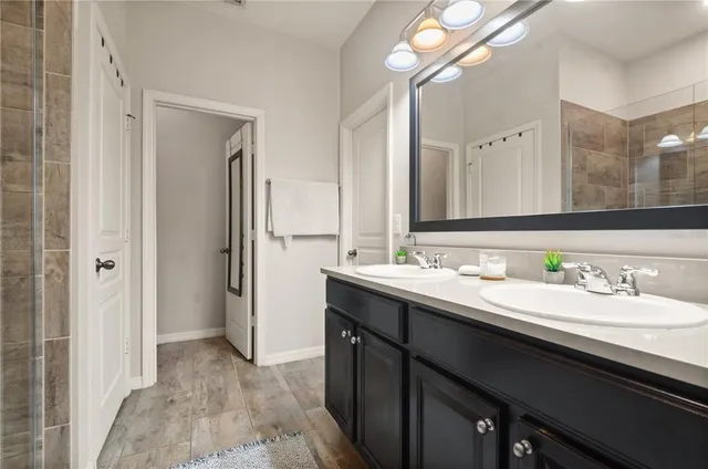 a bathroom with a double vanity sink and a mirror