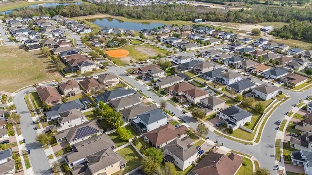 an aerial view of residential houses with outdoor space