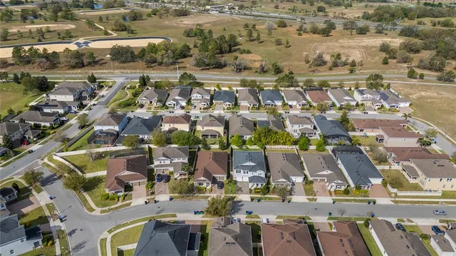 an aerial view of residential houses with outdoor space