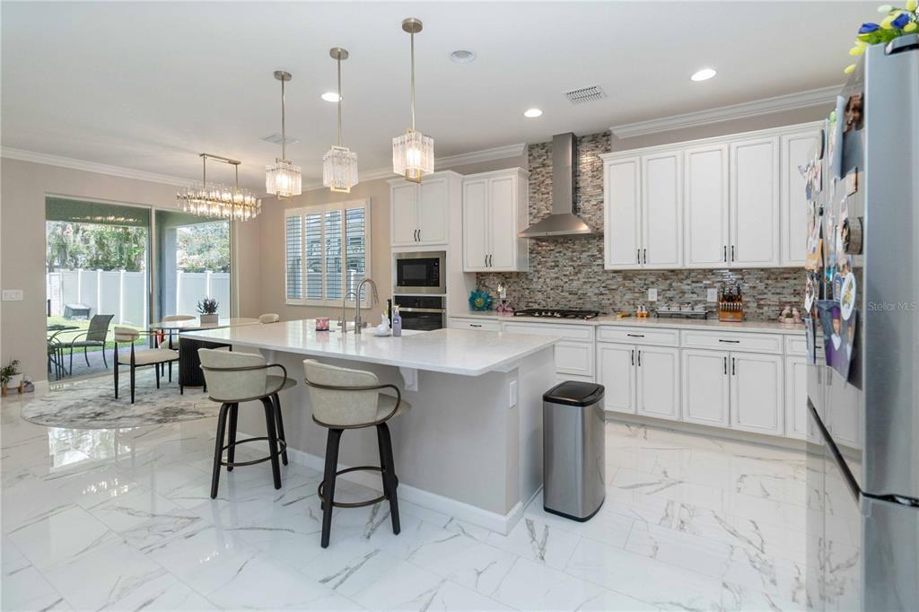 14327 Wabasso Loop Winter Garden, FL 34787 - Photo 15 of 48 a kitchen with cabinets and chairs