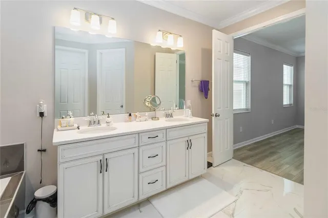 a bathroom with a tub sink and mirror