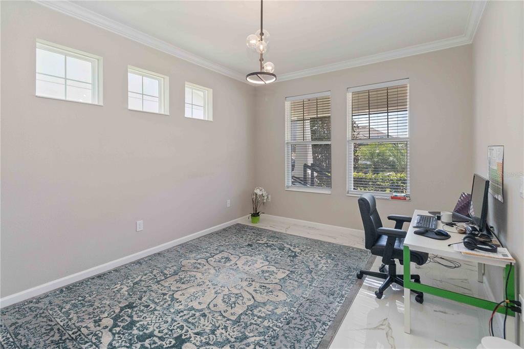 14327 Wabasso Loop Winter Garden, FL 34787 - Photo 22 of 48 a view of a workspace with furniture and a window