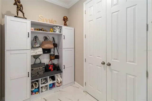 a bedroom with a large bed and a chandelier