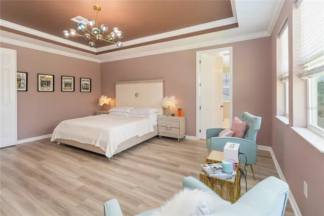 a bedroom with a bed and a chandelier