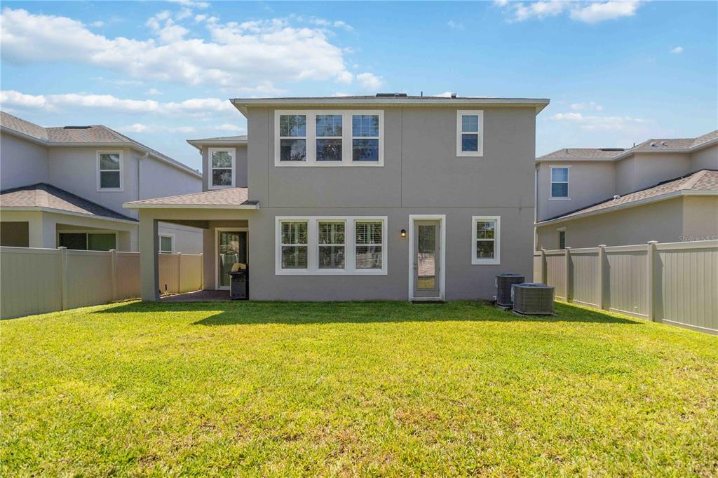 14327 Wabasso Loop Winter Garden, FL 34787 - Photo 46 of 48 a view of a brick house with a yard