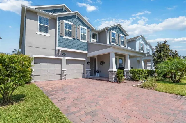 a front view of a house with yard and green space