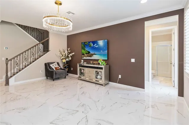 a living room with furniture potted plant and a chandelier