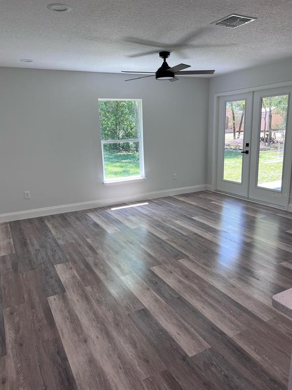 10268 North Harbor Way Citrus Springs, FL 34434 - Photo 12 of 23 an empty room with wooden floor and windows