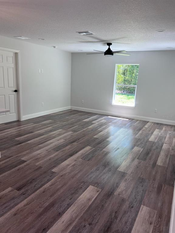 10268 North Harbor Way Citrus Springs, FL 34434 - Photo 13 of 23 an empty room with wooden floor cabinet and windows