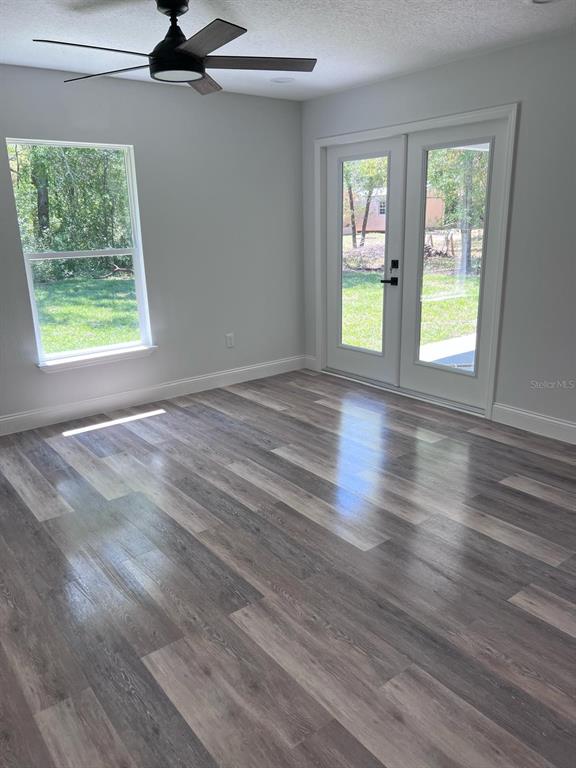 10268 North Harbor Way Citrus Springs, FL 34434 - Photo 14 of 23 a view of empty room with wooden floor and fan