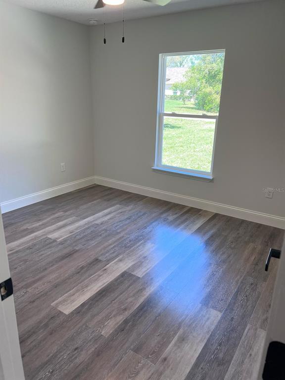 10268 North Harbor Way Citrus Springs, FL 34434 - Photo 16 of 23 a view of an empty room with wooden floor and a window