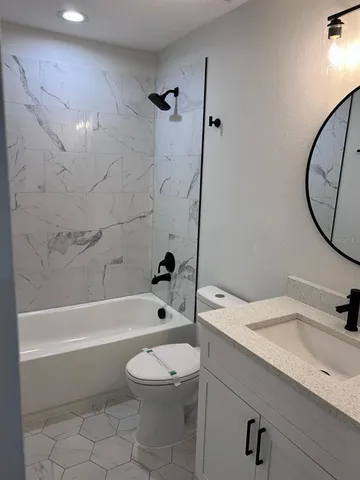 a bathroom with a sink a toilet and a bathtub