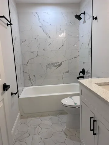 a bathroom with a sink a toilet and a bathtub
