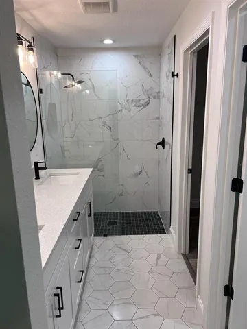 a bathroom with a sink a mirror and a shower