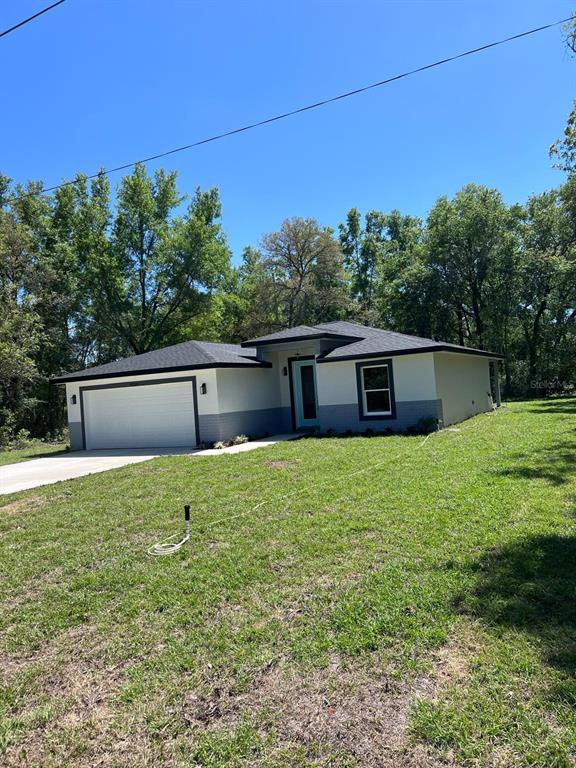 10268 North Harbor Way Citrus Springs, FL 34434 - Photo 2 of 23 a backyard of a house with lots of green space