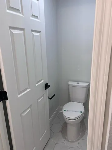 a white toilet sitting next to a sink