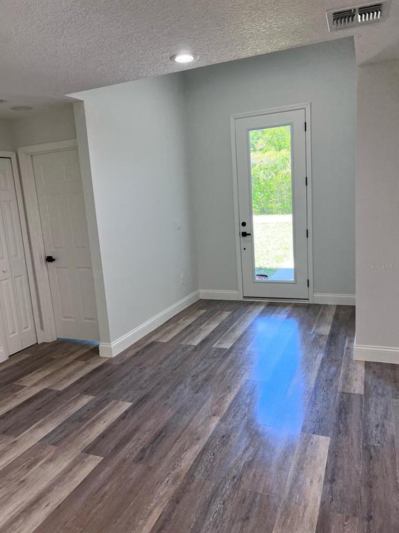 10268 North Harbor Way Citrus Springs, FL 34434 - Photo 8 of 23 an empty room with wooden floor and a window