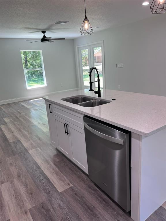10268 North Harbor Way Citrus Springs, FL 34434 - Photo 9 of 23 a kitchen with stainless steel appliances granite countertop a sink a microwave cabinets and wooden floor