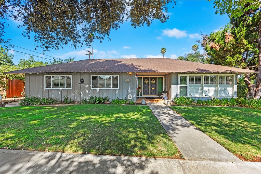 a front view of a house with a garden