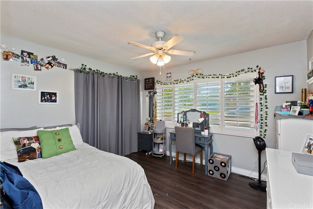 5201 Coventry Drive Riverside, CA 92506 - Photo 11 of 42 a bedroom with furniture and a chandelier
