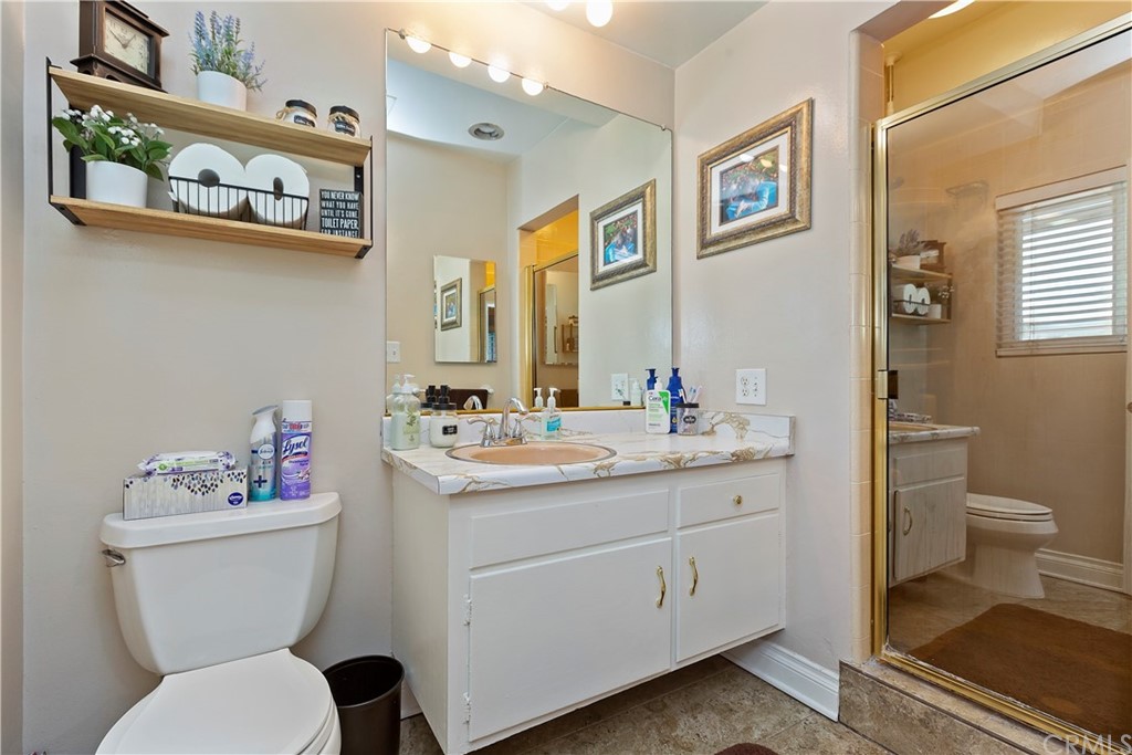 5201 Coventry Drive Riverside, CA 92506 - Photo 15 of 42 a bathroom with a toilet sink and mirror