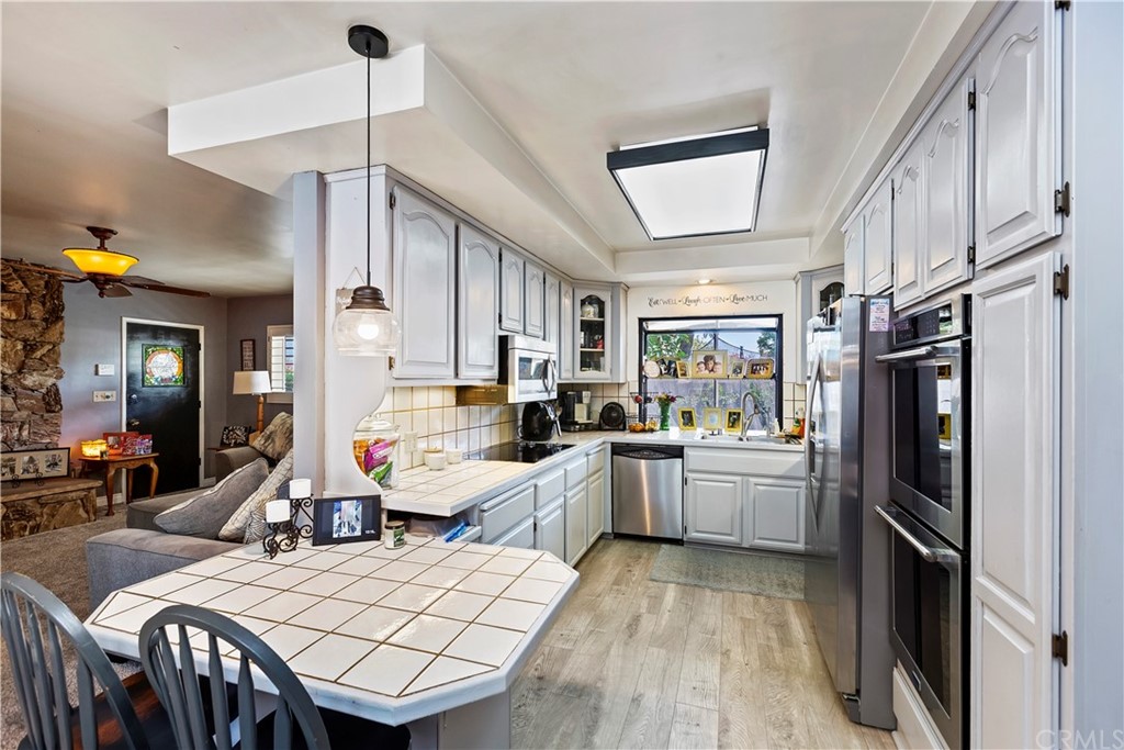 5201 Coventry Drive Riverside, CA 92506 - Photo 20 of 42 a large kitchen with sink a refrigerator and chairs