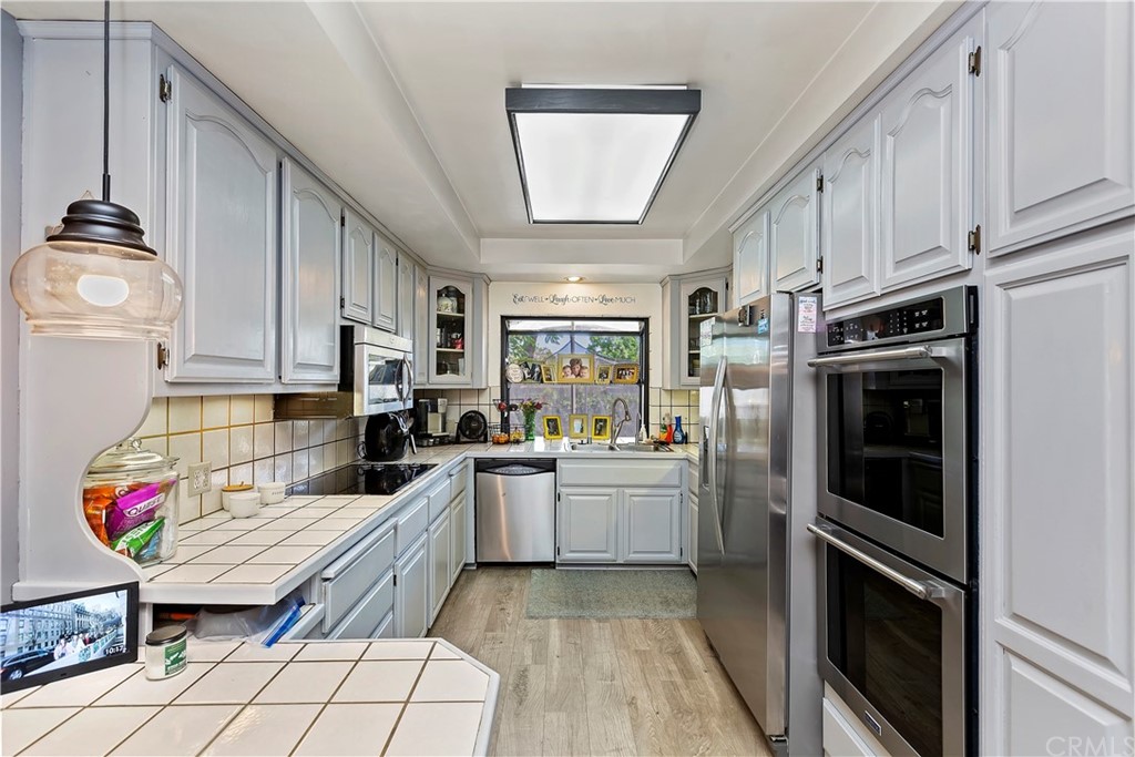 5201 Coventry Drive Riverside, CA 92506 - Photo 21 of 42 a kitchen with granite countertop a refrigerator stove top oven and sink